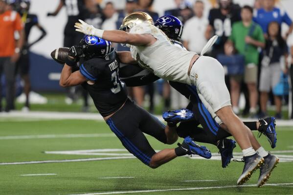 BYU linebacker Max Tooley (31) intercepts a pass intended for Notre Dame tight end Michael Mayer (87) during the second half of an NCAA college football game Saturday, Oct. 8, 2022, in Las Vegas. (AP Photo/John Locher)