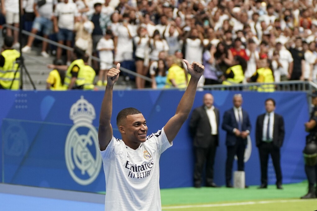 Kylian Mbappe, of France, gestures as he is presented to fans as a new Real Madrid player at the Santiago Bernabeu stadium in Madrid, Tuesday, July 16, 2024. (AP Photo/Andrea Comas)