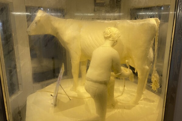 The famed Illinois State Fair Butter Cow was unveiled on Wednesday, Aug. 9, 2023, in Springfield, Ill., by Gov. J.B. Pritzker and Agriculture Director Jerry Costello II, previewing Friday's official opening of the annual state fair. (AP Photo/John O'Connor)