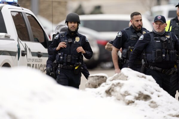 Police stand outside a King Soopers grocery store where a shooting took place Monday, March 22, 2021, in Boulder, Colo. (AP Photo/David Zalubowski)