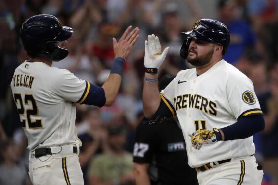 Milwaukee Brewers' Rowdy Tellez (11) is congratulated by Christian Yelich (22) after hitting a three-run home run during the first inning of a baseball game against the Minnesota Twins Wednesday, July 27, 2022, in Milwaukee. (AP Photo/Aaron Gash)