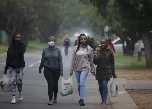 FILE - Students from the Tshwane University of Technology make their way back to their residence in Pretoria, South Africa, Saturday, Nov. 27, 2021. The world is racing to contain a new COVID-19 variant, which appears to be driving a surge in South Africa and is casting a pall there. (AP Photo/Denis Farrell, File)