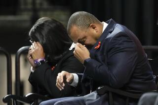 University of Virginia Athletic Director Carla Williams, left, and football coach Tony Elliott wipe tears from their eyes during a memorial service for three slain University of Virginia football players Lavel Davis Jr., D'Sean Perry and Devin Chandler at John Paul Jones Arena at the school in Charlottesville, Va., Saturday, Nov. 19, 2022. (AP Photo/Steve Helber, Pool)