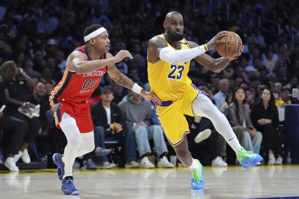 Los Angeles Lakers' LeBron James (23) drives past New Orleans Pelicans' Bruce Brown (00) during the second half of an NBA basketball game Tuesday, March 4, 2025, in Los Angeles. (AP Photo/Jae C. Hong)