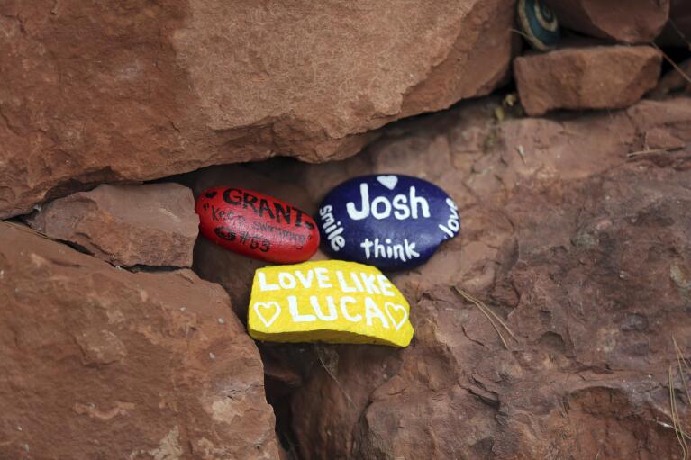 Rocks, painted to remember lost loved ones, are laid out at a quiet space in the Selah Carefarm in Cornville, Ariz., Oct. 4, 2022. (AP Photo/Dario Lopez-Mills)