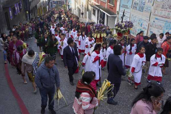 Catholics take part in a Palm Sunday procession in the Kaqchikel indigenous community of San Pedro Sacatepequez, Guatemala, Sunday, April 13, 2025. (AP Photo/Moises Castillo)