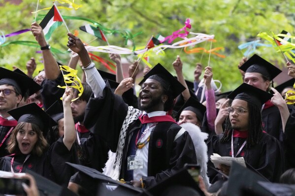 Students celebrate during commencement ceremonies at Harvard University, Thursday, May 29, 2025, in Cambridge, Mass. (AP Photo/Charles Krupa)