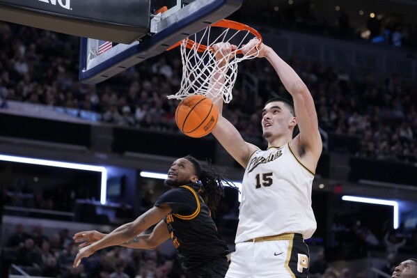 Purdue center Zach Edey (15) dunks the ball over Grambling State guard Jourdan Smith in the second half of a first-round college basketball game in the NCAA Tournament, Friday, March 22, 2024, in Indianapolis. (AP Photo/Michael Conroy)
