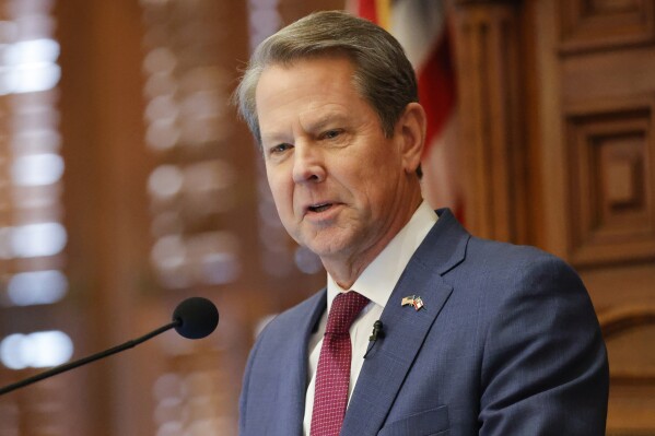 FILE - Georgia Gov. Brian Kemp delivers the State of the State address on the House floor of the state Capitol on Wednesday, Jan. 25, 2023 in Atlanta. Georgia is offering a new bargain to some adults without health insurance beginning Saturday, July 1, 2023, — go to work or school and the state will cover you. But advocates decry the plan, which will insure far fewer people than a full expansion of the state-federal Medicaid program, as needlessly restrictive and expensive. (AP Photo/Alex Slitz, File)