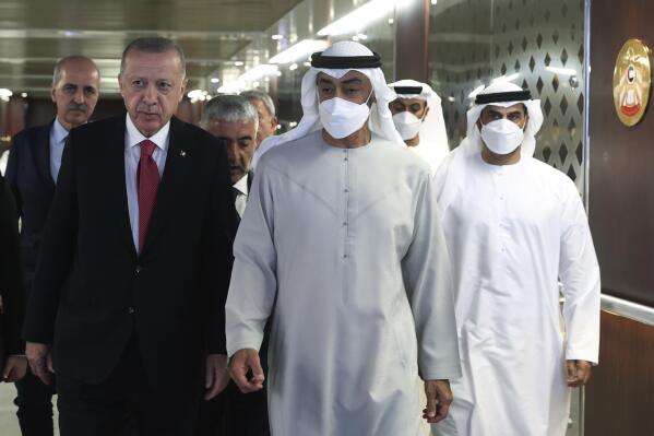 Turkish President Recep Tayyip Erdogan, left, and Sheikh Mohammed bin Zayed Al Nahyan, center, walk before a meeting in Abu Dhabi, United Arab Emirates, Tuesday, May 17, 2022. Erdogan travelled to Abu Dhabi Tuesday to offer his condolences on the death of the United Arab Emirates' late ruler and meet with the federation's newly ascended president. Erdogan met with Sheikh Mohammed bin Zayed Al Nahyan, who ascended the presidency following the death of Sheikh Khalifa bin Zayed Al Nahyan. (Turkish Presidency via AP)