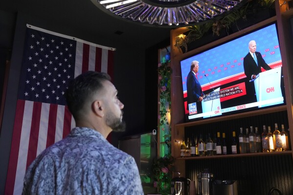 A patron watches President Joe Biden debate Republican presidential candidate and former President Donald Trump during a debate watch party Thursday, June 27, 2024, in Scottsdale, Ariz. (AP Photo/Ross D. Franklin)