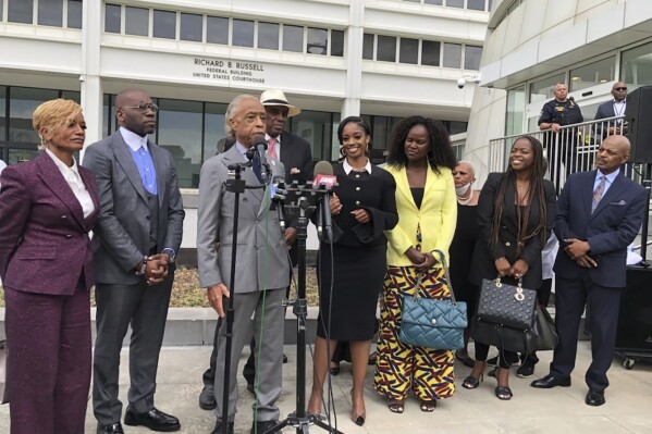 The Rev. Al Sharpton speaks outside the Richard B. Russell federal courthouse in Atlanta, on Tuesday, Sept. 26, 2023. To his left in the black dress is Fearless Fund CEO and co-founder Arian Simone. A judge Tuesday refused to block a grant program the fund administers for Black women entrepreneurs, saying a lawsuit arguing it illegally excluded other races was not likely to succeed. (AP Photo/Curlan Campbell)