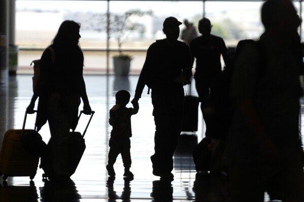File - People pass through Salt Lake City International Airport on June 30, 2023, in Salt Lake City. The Federal Aviation Administration predicts Labor Day weekend will be the third busiest holiday travel weekend of the year so far. (AP Photo/Rick Bowmer, File)