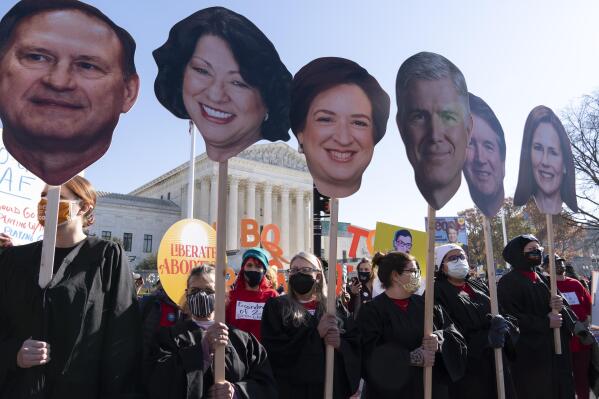 Abortion rights advocates holding cardboard cutouts of the Supreme Court Justices, demonstrate in front of the U.S. Supreme Court Wednesday, Dec. 1, 2021, in Washington, as the court hears arguments in a case from Mississippi, where a 2018 law would ban abortions after 15 weeks of pregnancy, well before viability. (AP Photo/Jose Luis Magana)