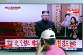 
              A man walks by a TV screen showing a local news program with a file image of North Korean leader Kim Jong Un, at Seoul Train Station in Seoul, South Korea, Wednesday, Aug. 9, 2017. North Korea and the United States traded escalating threats, with President Donald Trump threatening Pyongyang "with fire and fury like the world has never seen" and the North's military claiming Wednesday it was examining its plans for attacking Guam. The letters read " North Korea, Denouncing the U.N. Security Council's sanctions." (AP Photo/Lee Jin-man)
            