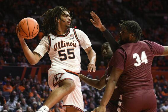 Illinois' Skyy Clark (55) looks to pass the ball as Alabama A&M's EJ Williams (34) and Lorenzo Downey, center, defend during the first half of an NCAA college basketball game, Saturday, Dec. 17, 2022, in Champaign, Ill. (AP Photo/Michael Allio)