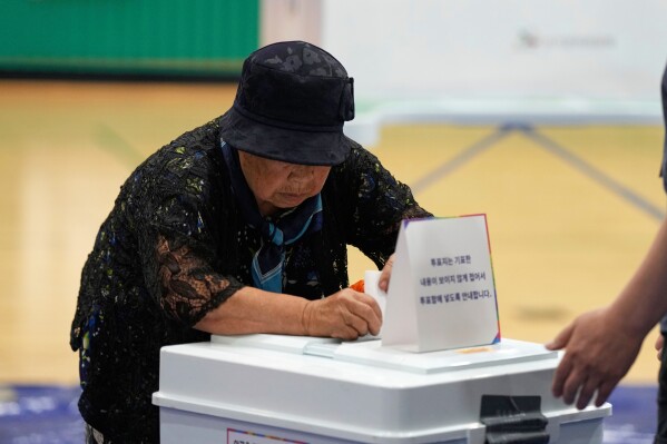 A woman casts her vote for the presidential election at a polling station in Seoul, South Korea, Tuesday, June 3, 2025. (AP Photo/Lee Jin-man)