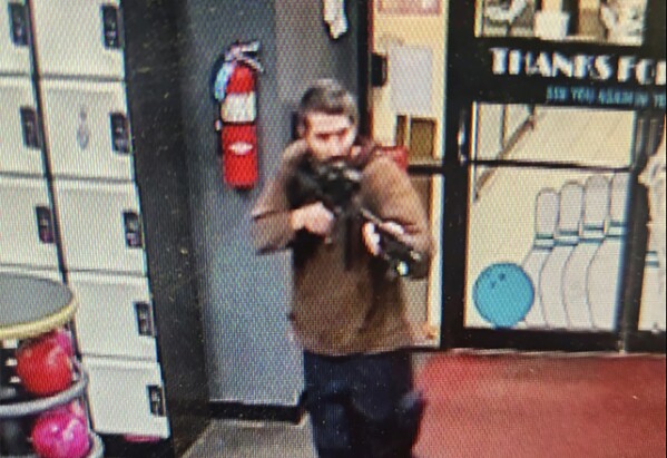 In this image taken from video provided by the Androscoggin County Sheriff's Office, Robert Card points a gun while entering a bowling alley in Lewiston, Maine, on Wednesday, Oct. 25, 2023. The body of Card, suspected of killing multiple people at the bowling alley and a bar, was found Friday, Oct. 27, with an apparent self-inflicted gunshot wound. (Androscoggin County Sheriff's Office via AP)