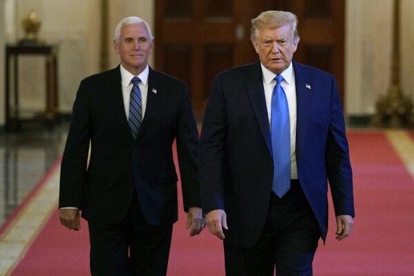 President Donald Trump and Vice President Mike Pence arrive to speak at a roundtable with people positively impacted by law enforcement, Monday, July 13, 2020, in Washington. (AP Photo/Evan Vucci)