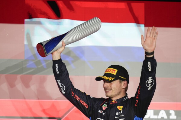 Red Bull driver Max Verstappen of the Netherlands stands on the podium after winning the Qatar Formula One Grand Prix at the Lusail International Circuit in Lusail, Qatar, Sunday, Dec. 1, 2024. (AP Photo/Darko Bandic)