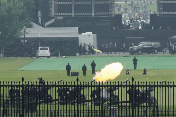 Members of the military fire cannons as part of a 21-gun salute during an event to honor the Army's 250th anniversary, coinciding with President Donald Trump's 79th birthday, Saturday, June 14, 2025, in Washington. (AP Photo/Mark Schiefelbein)
