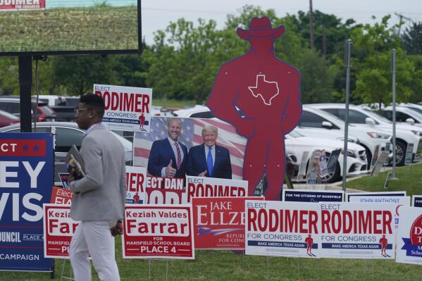 Sign supporting various candidates sit outside an early voting location Tuesday, April 27, 2021, in Mansfield, Texas. (AP Photo/LM Otero)