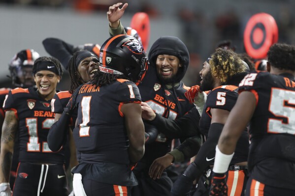 Oregon State running back Deshaun Fenwick (1) celebrates with teammates after scoring a touchdown against Stanford during the second half of an NCAA college football game Saturday, Nov. 11, 2023, in Corvallis, Ore. Oregon State won 62-17. (AP Photo/Amanda Loman)