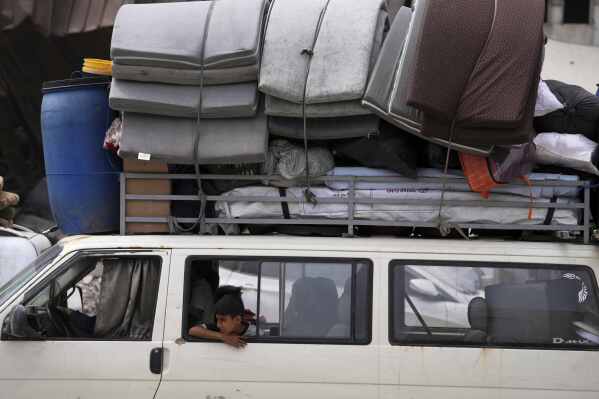 Displaced Palestinians fleeing Beit Lahia amid ongoing Israeli military operations in the Gaza Strip arrive in Jabalia, northern Gaza, on Sunday, May 18, 2025. (AP Photo/Jehad Alshrafi)