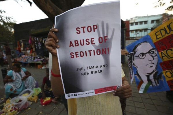 FILE-A woman holds a placard protesting against the sedition case filed by police against a school after a play performed by students denouncing a new citizenship law, in Bangalore, India, Tuesday, Feb. 4, 2020. India's government on Friday, Aug. 11, 2023, introduced a bill in Parliament that seeks to replace a British colonial-era law dealing with sedition charges with its own version. (AP Photo/Aijaz Rahi, File)