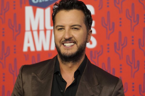 FILE - In this June 5, 2019 file photo, Luke Bryan arrives at the CMT Music Awards at the Bridgestone Arena in Nashville, Tenn. Paula Abdul is set to return as a guest judge on Monday night's first live episode of American Idol replacing Luke Bryan, who announced he tested positive for COVID-19. (AP Photo/Sanford Myers, File)