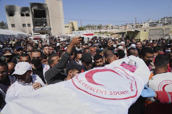 Mourners carry the bodies of 8 Red Crescent emergency responders, recovered in Rafah a week after an Israeli attack, as they are transported for burial from a hospital in Deir al-Balah, Gaza Strip, on Monday, March 31, 2025. (AP Photo/Abdel Kareem Hana)