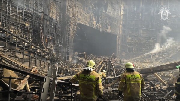 In this photo taken from video released by the Investigative Committee of Russia on Saturday, March 23, 2024, firefighter work in the burned concert hall after an attack on the building of the Crocus City Hall on the western edge of Moscow, Russia. (Investigative Committee of Russia via AP)