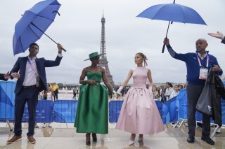FILE - Cynthia Erivo, left, and Ariana Grande arrive in Paris, France, before the opening ceremony of the 2024 Summer Olympics, Friday, July 26, 2024. In "Wicked," Elphaba and Glinda travel from Shiz University to the Emerald City on a glistening green train to meet the wizard. In real life, Cynthia Erivo and Ariana Grande have traveled much farther and wider and longer and on airplanes to promote their hotly anticipated film. (AP Photo/Natacha Pisarenko, File)