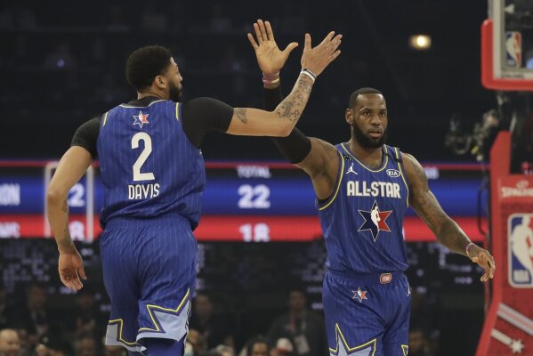 LeBron James of the Los Angeles Lakers high fives Anthony Davis of the Los Angeles Lakers uring the first half of the NBA All-Star basketball game Sunday, Feb. 16, 2020, in Chicago. (AP Photo/Nam Huh)