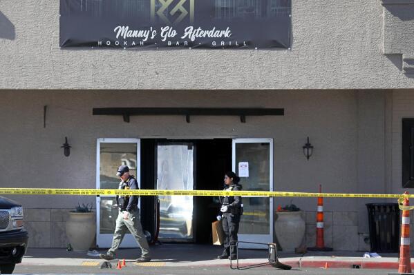 FILE - Las Vegas police investigate at Manny's Glow Ultra Lounge & Restaurant, after a shooting on Feb. 26, 2022, in Las Vegas. Eleven attempted murder charges were dropped and a 44-year-old ex-convict pleaded guilty Wednesday, May 18, 2022, to a single felony charge in a deadly shootout at a Las Vegas lounge that killed a man and injured at least 12 others. (Chitose Suzuki/Las Vegas Review-Journal via AP, File)
