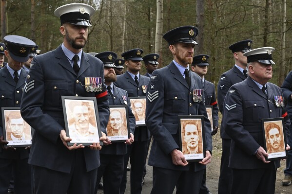 British soldiers pay tribute to Allied prisoners of war who tunneled out of a German POW camp during World War II on the 80th anniversary of the escape, in Zagan, Poland, Sunday March 24, 2024. The ingenious act of defiance has come to be known as the "Great Escape." Most of the soldiers who escaped from Stalag Luft III on the night of March 24, 1944, faced a tragic end. Only three made it to safety. The others were recaptured and 50 of them were executed. (AP Photo/Jan Mazur)