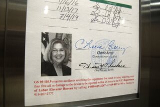A photo of state Labor Commissioner Cherie Berry is displayed on an elevator inspection certificate in Raleigh, N.C., on Tuesday, April 2, 2019. Berry, who was sworn in as North Carolina's first female labor commissioner in January 2001, announced Tuesday that she would not seek re-election when her term ends next year. (AP Photo/Allen G. Breed)