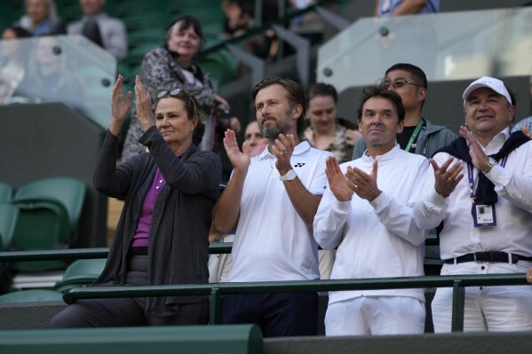 Pam Shriver, left, applauds after Croatia's Donna Vekic defeats Sloane Stephens of the US in the women's singles match on day four of the Wimbledon tennis championships in London, Thursday, July 6, 2023. (AP Photo/Alastair Grant)