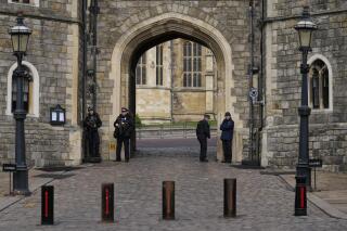 FILE - Police guard the Henry VIII gate to Windsor Castle in Windsor, England, Wednesday, Feb. 16, 2022. British prosecutors have charged on Tuesday. Aug. 2, 2022, a man with intending to “injure or alarm” Queen Elizabeth II after he was arrested at Windsor Castle on Christmas Day of 2021. Jaswant Singh Chail, 20, has been charged under the Treason Act after allegedly being caught with a crossbow on the palace grounds. (AP Photo/Alastair Grant, File)