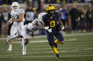 Michigan wide receiver Ronnie Bell (8) runs after a catch as Michigan State cornerback Kendell Brooks (33) defends in the second half of an NCAA college football game in Ann Arbor, Mich., Saturday, Oct. 29, 2022. (AP Photo/Paul Sancya)