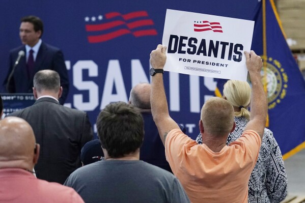 A supporter holds up a sign for Republican presidential candidate Florida Gov. Ron DeSantis during a campaign event, Monday, July 31, 2023, in Rochester, N.H. (AP Photo/Charles Krupa)