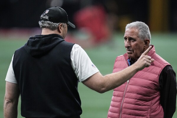 Atlanta Falcons owner Arthur Blank, right, talks with head coach Arthur Smith during the the team's NFL minicamp football practice, Tuesday, June 13, 2023, in Atlanta. (AP Photo/John Bazemore)