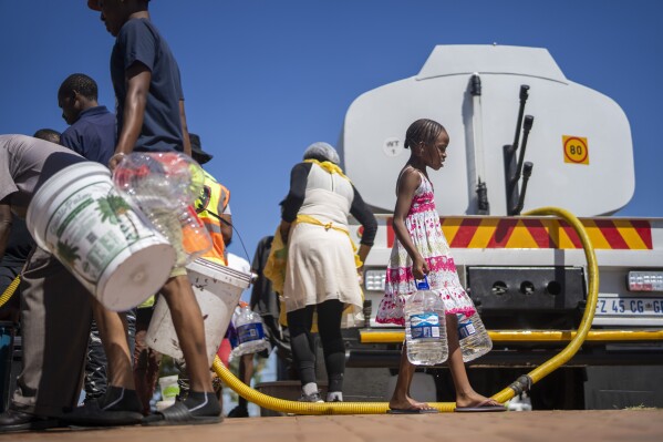 Residents of the township of Soweto, South Africa, queue for water Saturday, March 16, 2024. Thousands of South Africans are lining up for water as the country's largest city, Johannesburg, confronts an unprecedented collapse of its water system affecting millions of people. Residents rich and poor have never seen a shortage of this severity. (AP Photo/Jerome Delay)