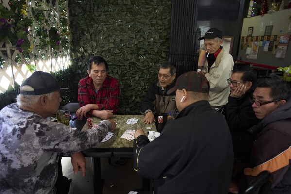 A group of Vietnamese men play cards outside a cafe in the Little Saigon neighborhood of Westminster, Calif., Tuesday, April 22, 2025. (AP Photo/Jae C. Hong)