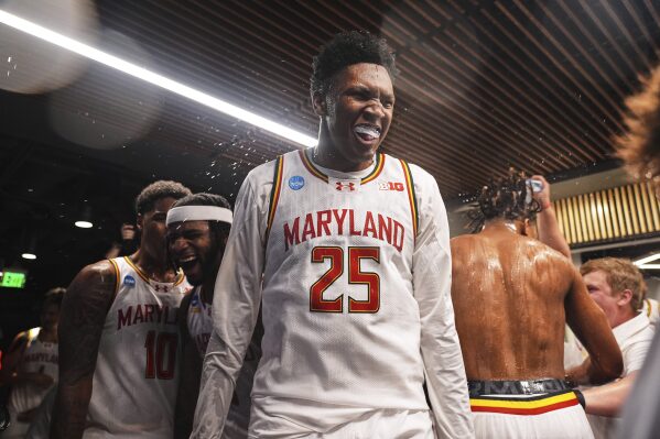 Maryland center Derik Queen celebrates with teammates after making the winning basket for a 72-71 win over Colorado State in the second round of the NCAA college basketball tournament Sunday, March 23, 2025, in Seattle. (AP Photo/Lindsey Wasson)