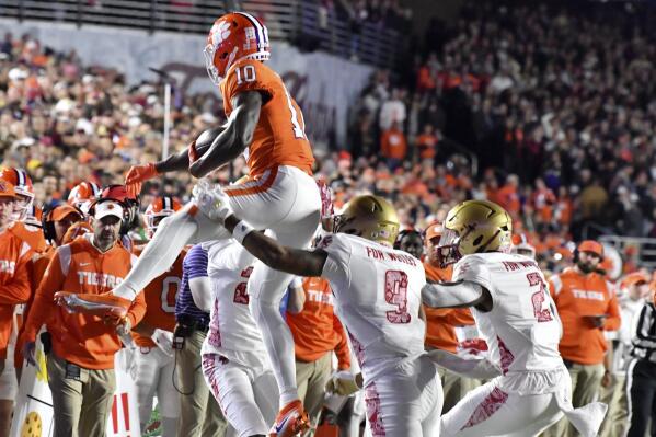 Clemson's Joseph Ngata (10) makes a reception despite the Boston College defense during the first half of an NCAA college football game Saturday, Oct. 8, 2022, in Boston. (AP Photo/Mark Stockwell)