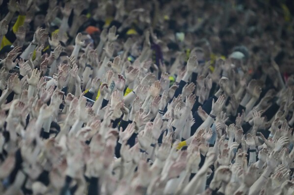 Borussia Dortmund fans sing during the Champions League quarterfinals second leg soccer match against Barcelona, at the Signa-Iduna Park in Dortmund, Germany, April 15, 2025. (AP Photo/Martin Meissner)