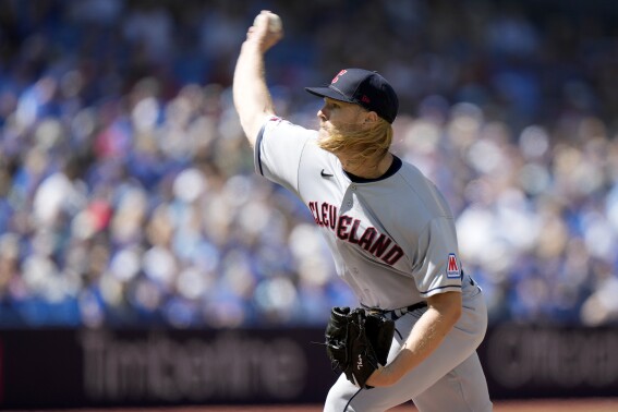 Cleveland Guardians starting pitcher Noah Syndergaard (34) works against the Toronto Blue Jays during the first inning of a baseball game in Toronto, Sunday, Aug. 27, 2023. (Frank Gunn/The Canadian Press via AP)