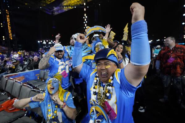 Los Angeles Chargers fans cheer during the third round of the NFL football draft, Friday, April 28, 2023, in Kansas City, Mo. (AP Photo/Charlie Riedel)