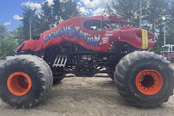 This photo provided by the Topsham Police Department shows a lobster-themed monster truck that clipped an aerial power line, toppling several utility poles while performing for a crowd at the Topsham Fairgrounds on Saturday, June 1, 2024. (Topsham Police Department via AP)